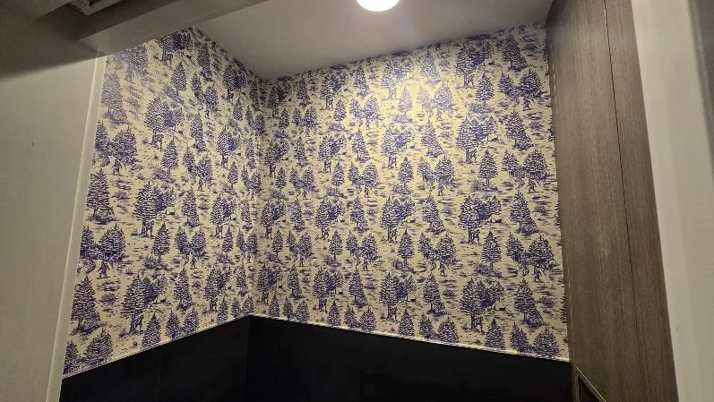 Modern wallpaper installation in a living room